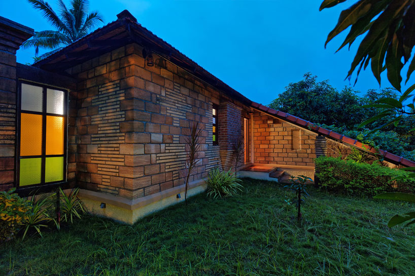 Elongated tiled roof shelters the entrance foyer and secures the visual privacy of bedroom.