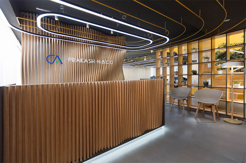 While entering from the lobby, a large cement finished sliding door with a well-ordered signage opens into the reception with waiting area.