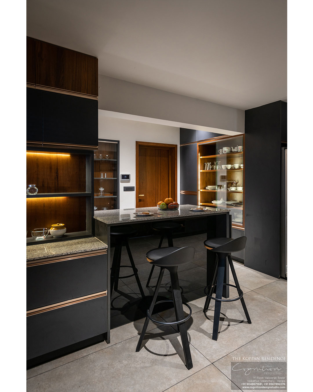 The Kitchen with black, wood and rose gold as finishes.