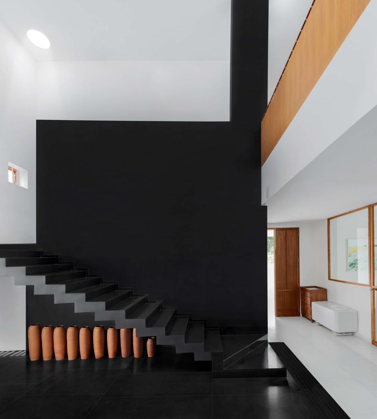 Black Staricase of The Courtyard House by Atelier Varun Goyal