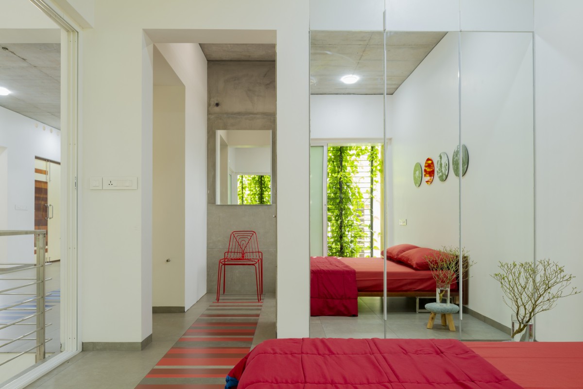 First Floor Red Bedroom of The House That Rains Light by LIJO.RENY.Architects