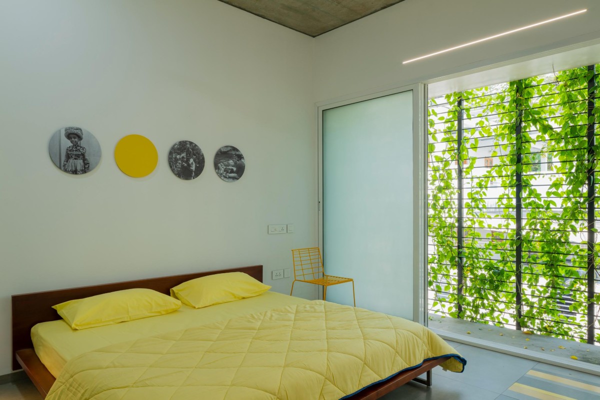 First Floor Yellow Bedroom of The House That Rains Light by LIJO.RENY.Architects