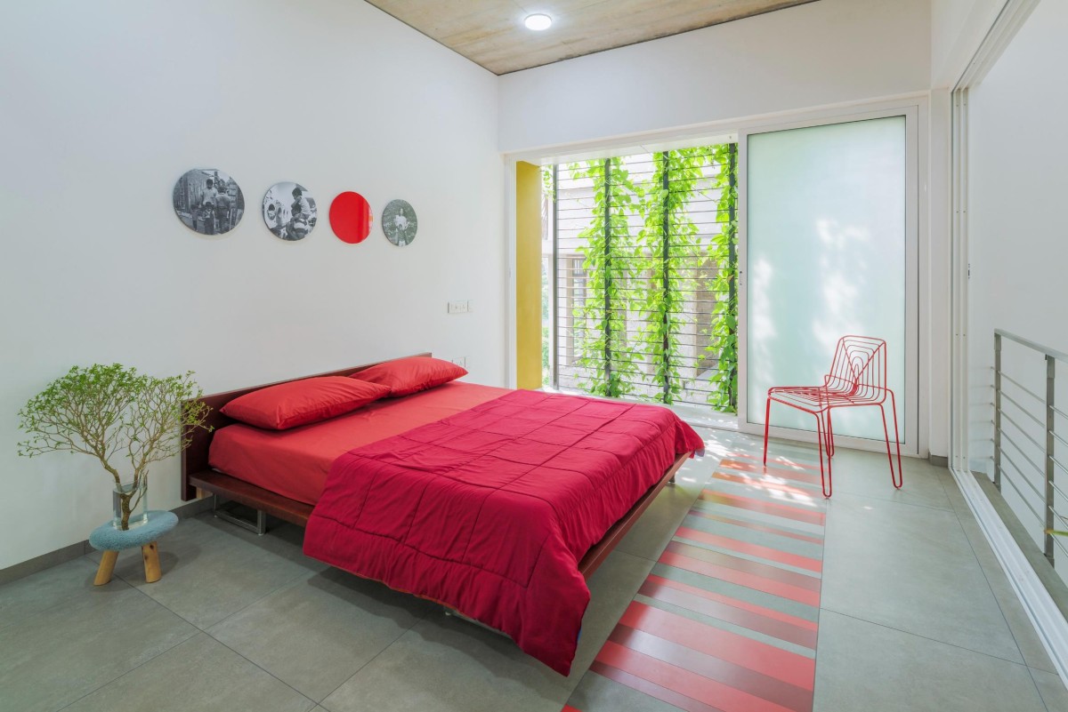 First Floor Red Bedroom of The House That Rains Light by LIJO.RENY.Architects