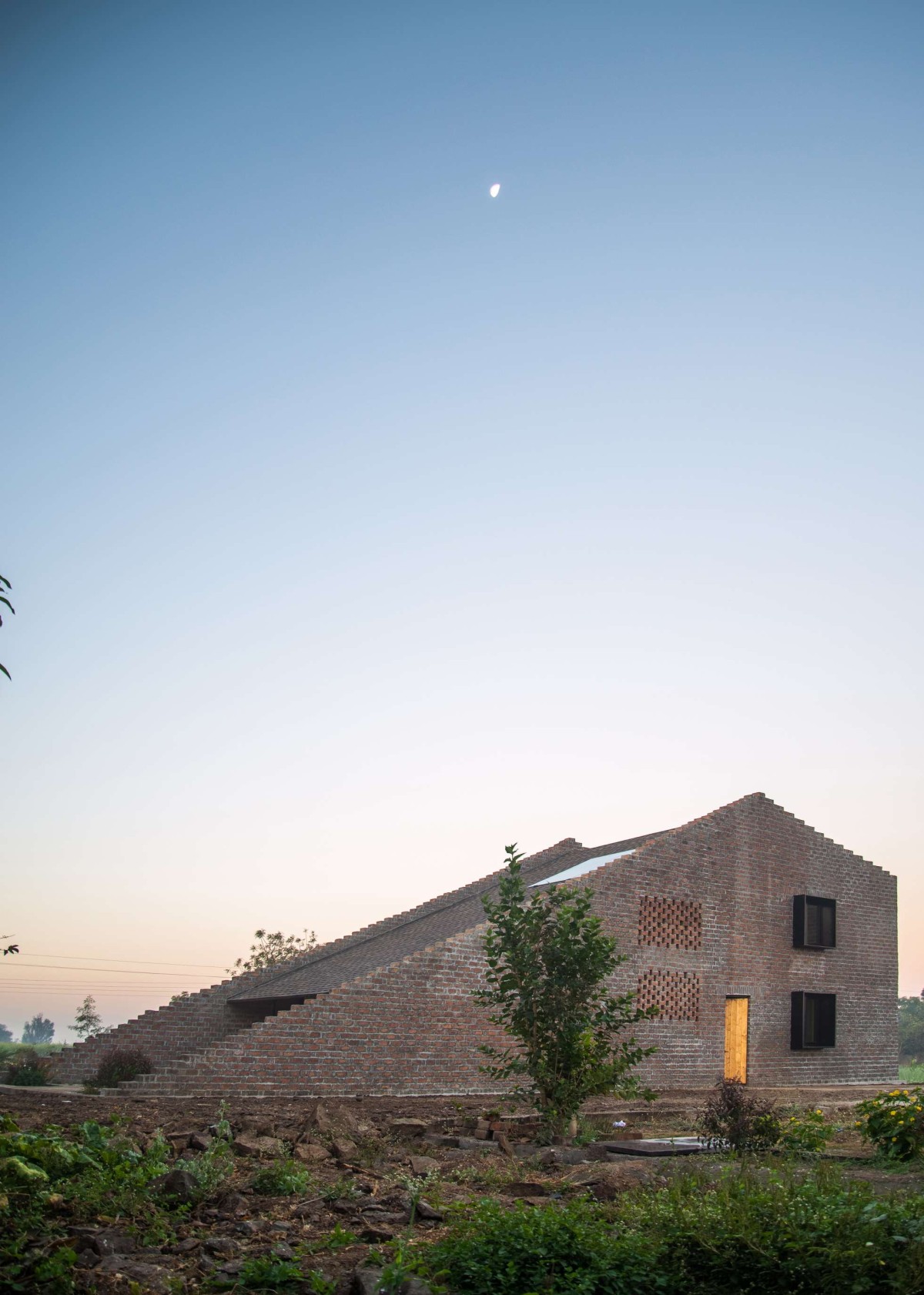 Exterior view of Half Is More – House in Progress by Atelier Shantanu Autade + Studio Boxx