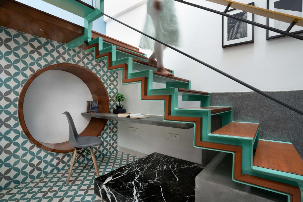 Study area under the staircase of Athulyam by Outlined Architects