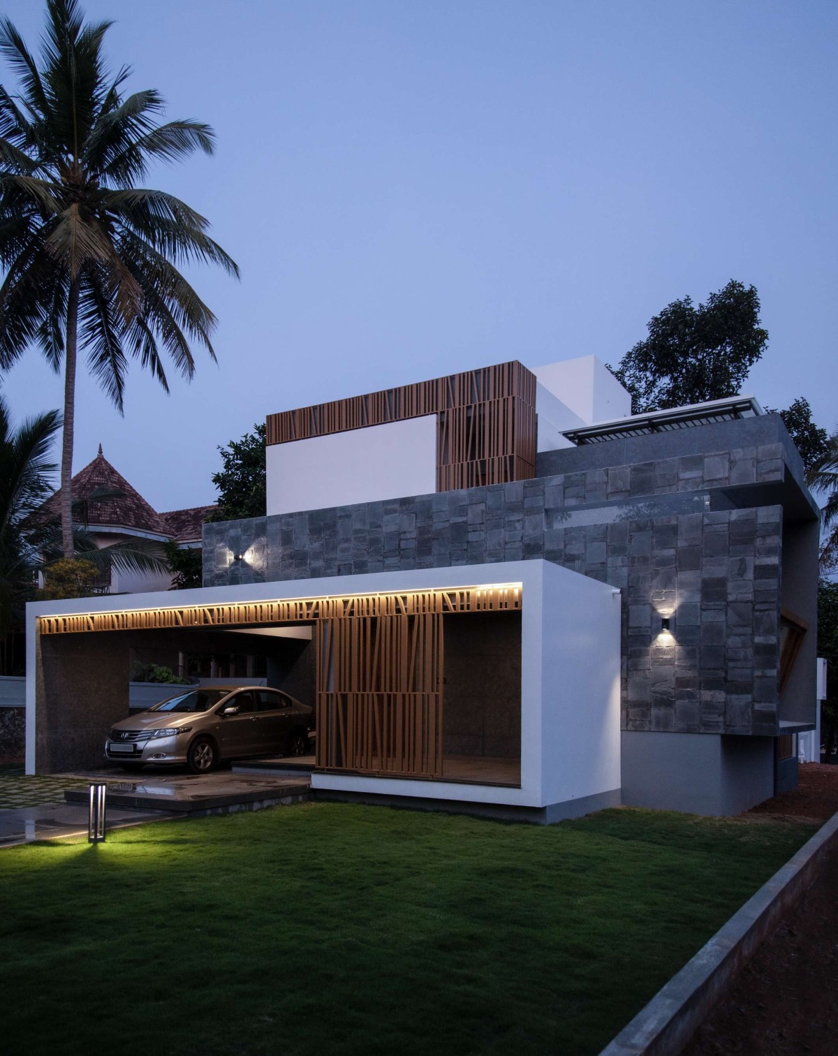 Night shot of exterior view of Amballoor Residence by N&RD