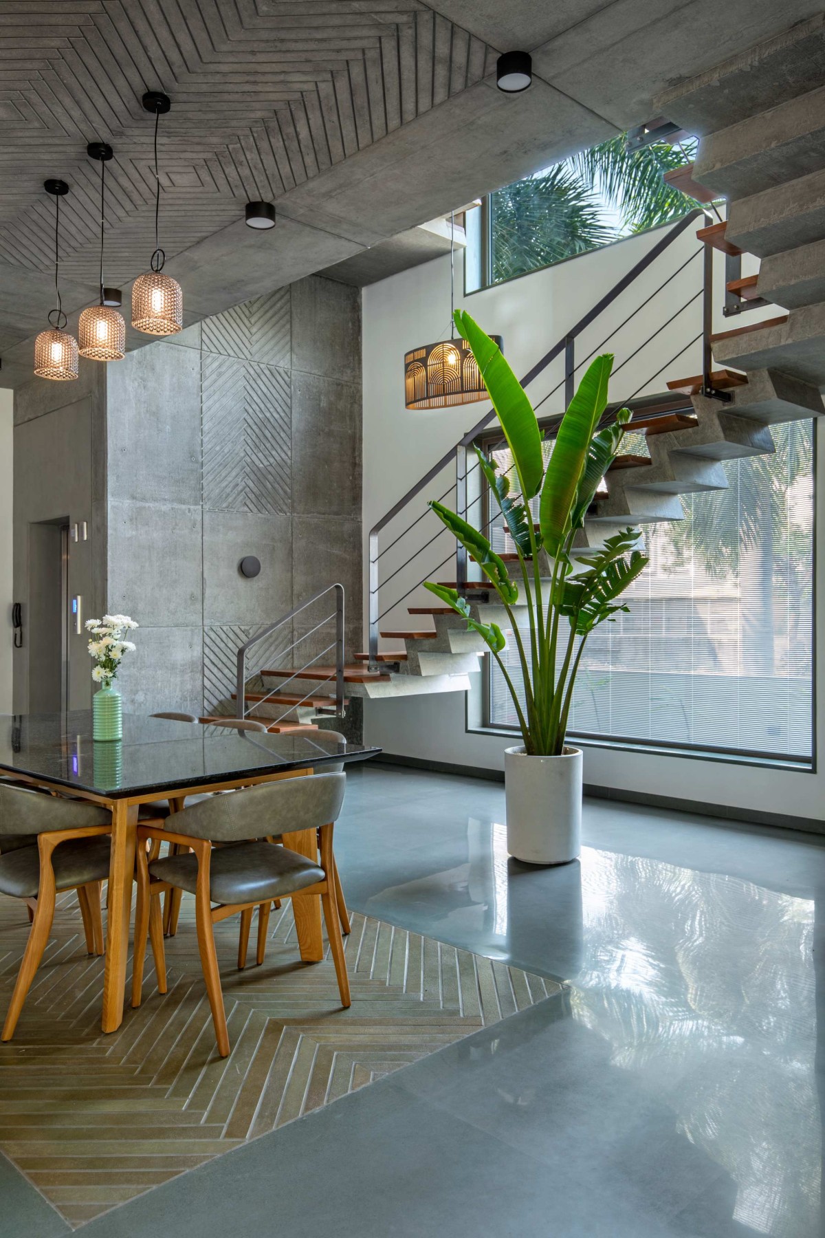 Dining Area and Staircase of Royal Acre Residence by K.N. Associates