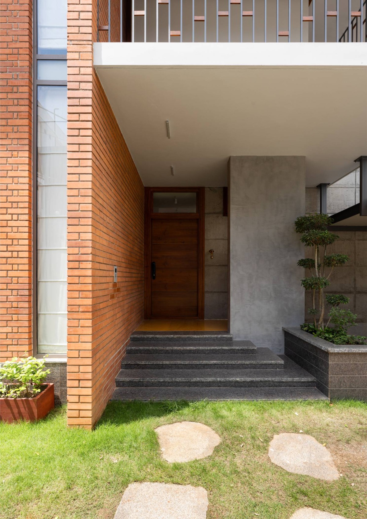 Entrance of Carving a COURT OF QUIETUDE in a Bustling Cityscape by Mudbricks Architects
