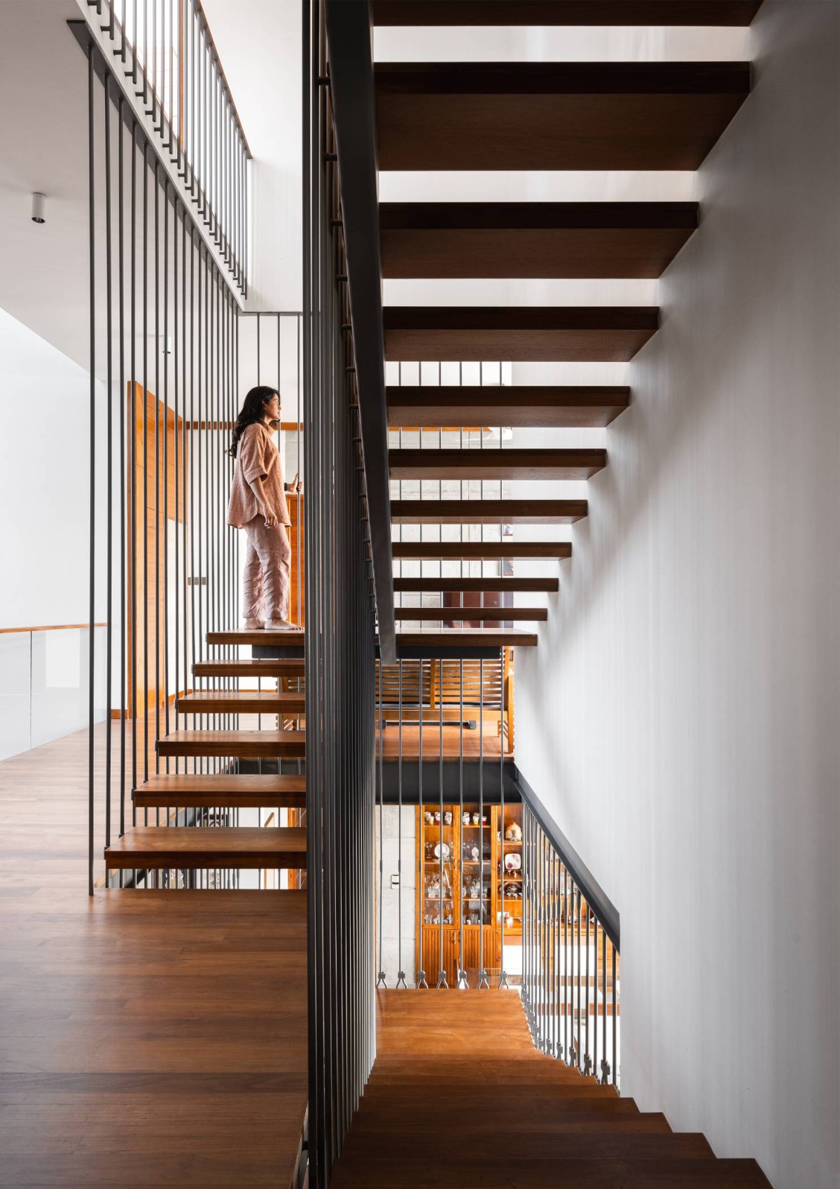 Staircase of Carving a COURT OF QUIETUDE in a Bustling Cityscape by Mudbricks Architects