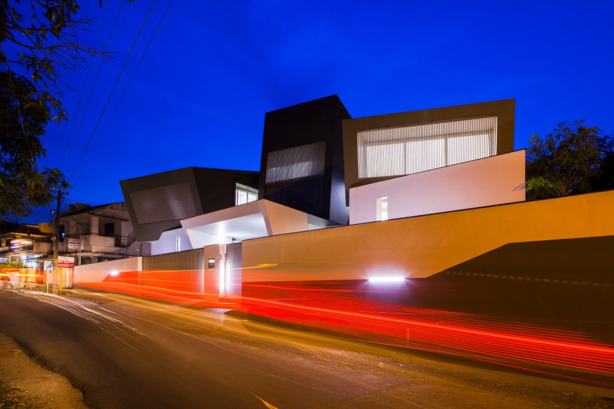 Night shot of exterior view of The Skewed House by LIJO.RENY.architects