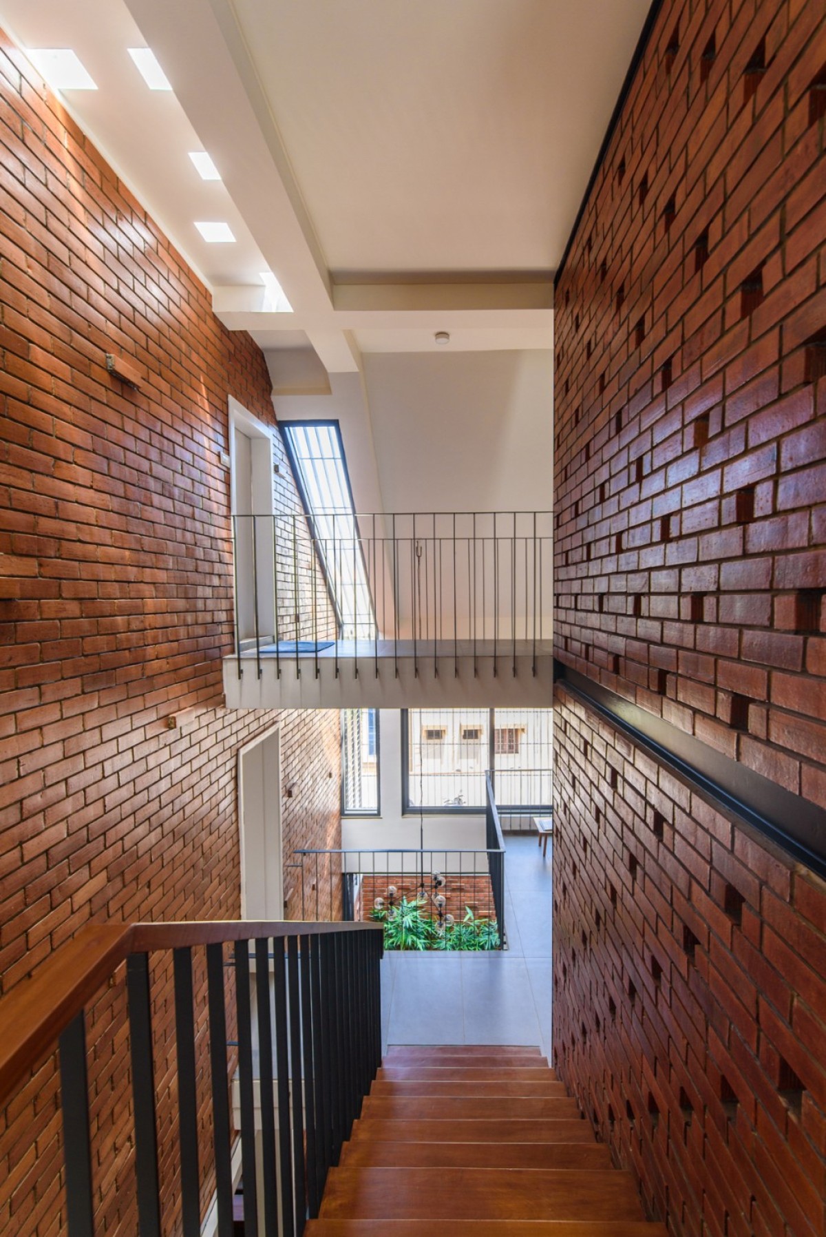 Staircase-a visually connected space within the staircase void of Corner Brick House by Jacob + Rathodi Architects