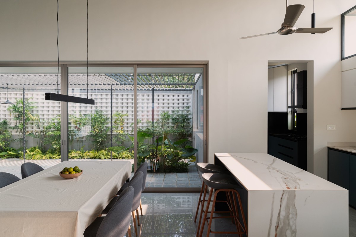 Dining and Kitchen of Athira-Paras Residence by Studio Acis