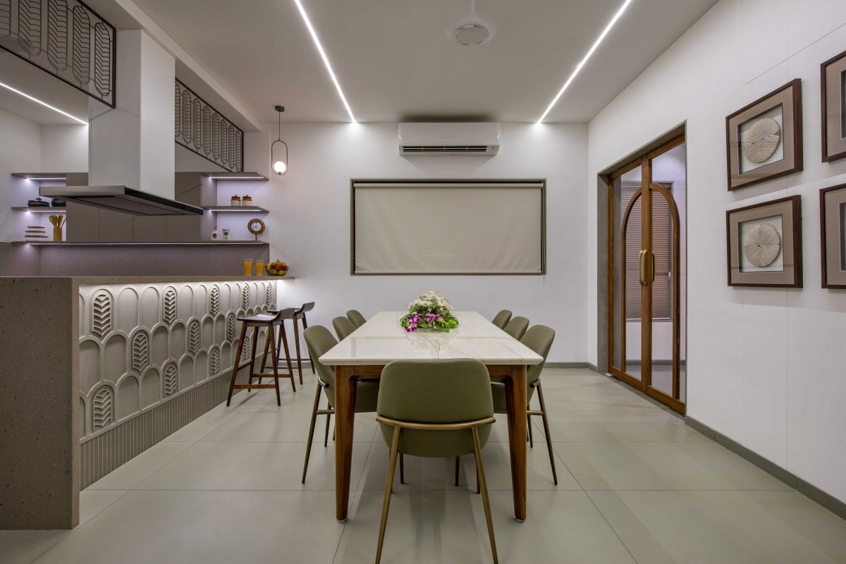 Dining and Kitchen of Concrete Screen Bungalow by DP Dimensions