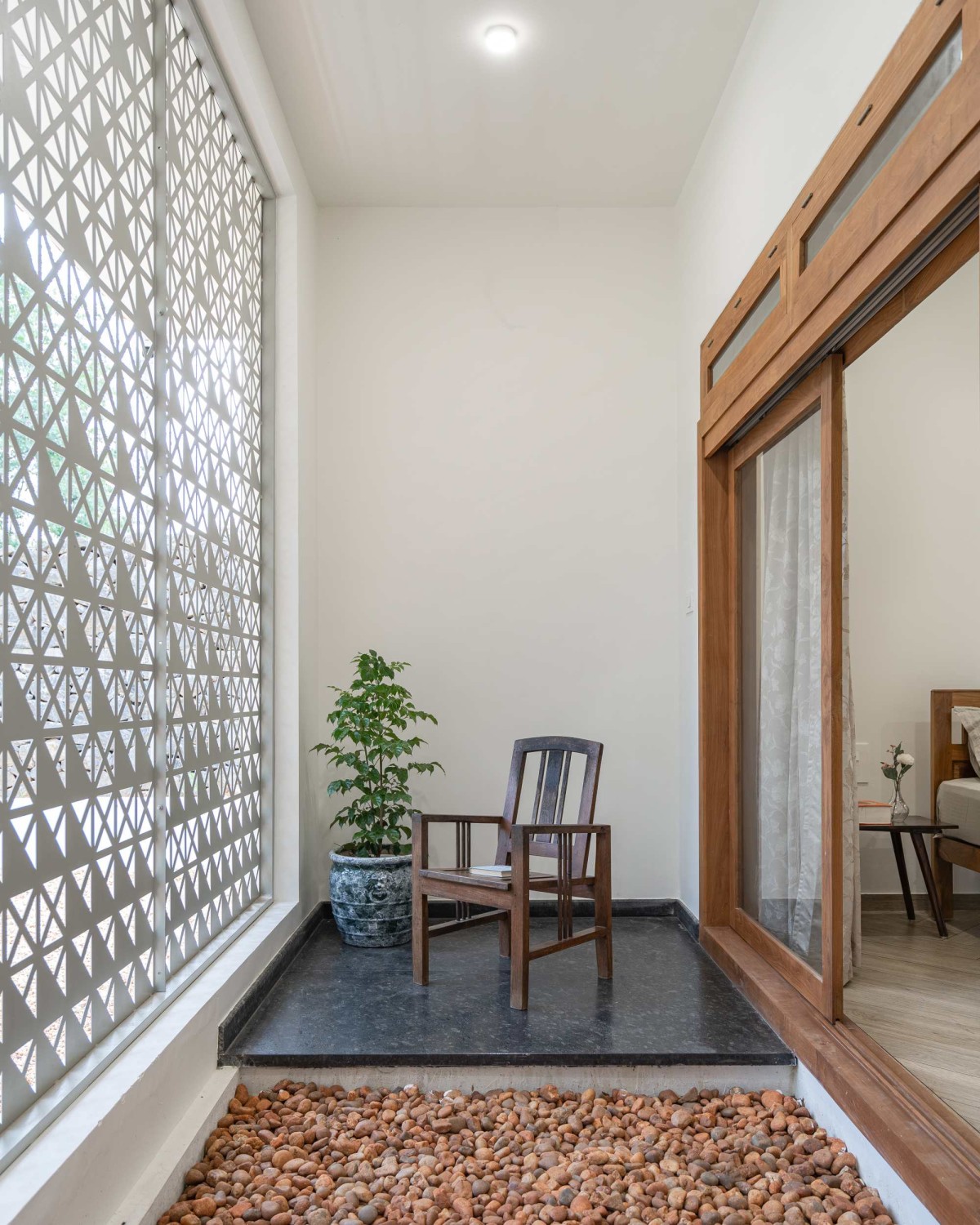 Seating area at court connected to bedroom of Arackal Madom by In Between Space Architects