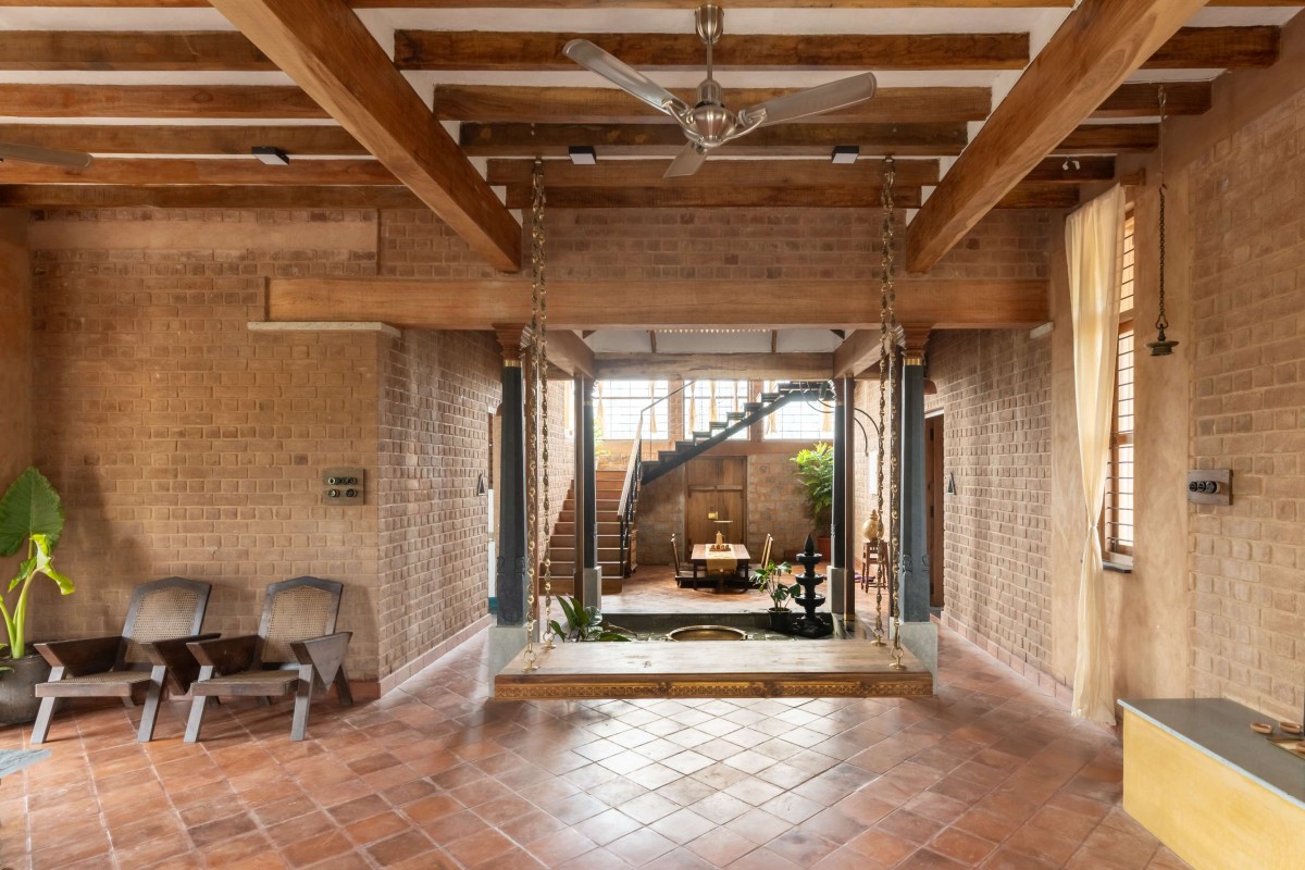 Living room and Courtyard of Brick Manor by Bhutha Earthen Architecture Studio