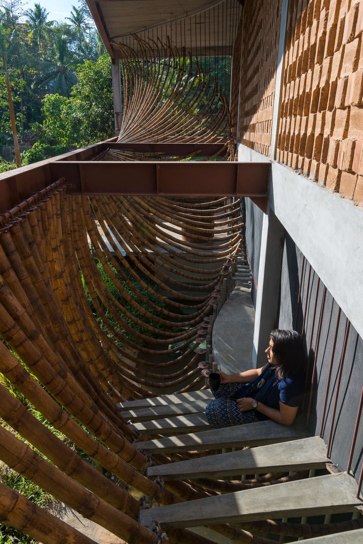 View of the extended staircase and bamboo of Iha Residence by Wallmakers
