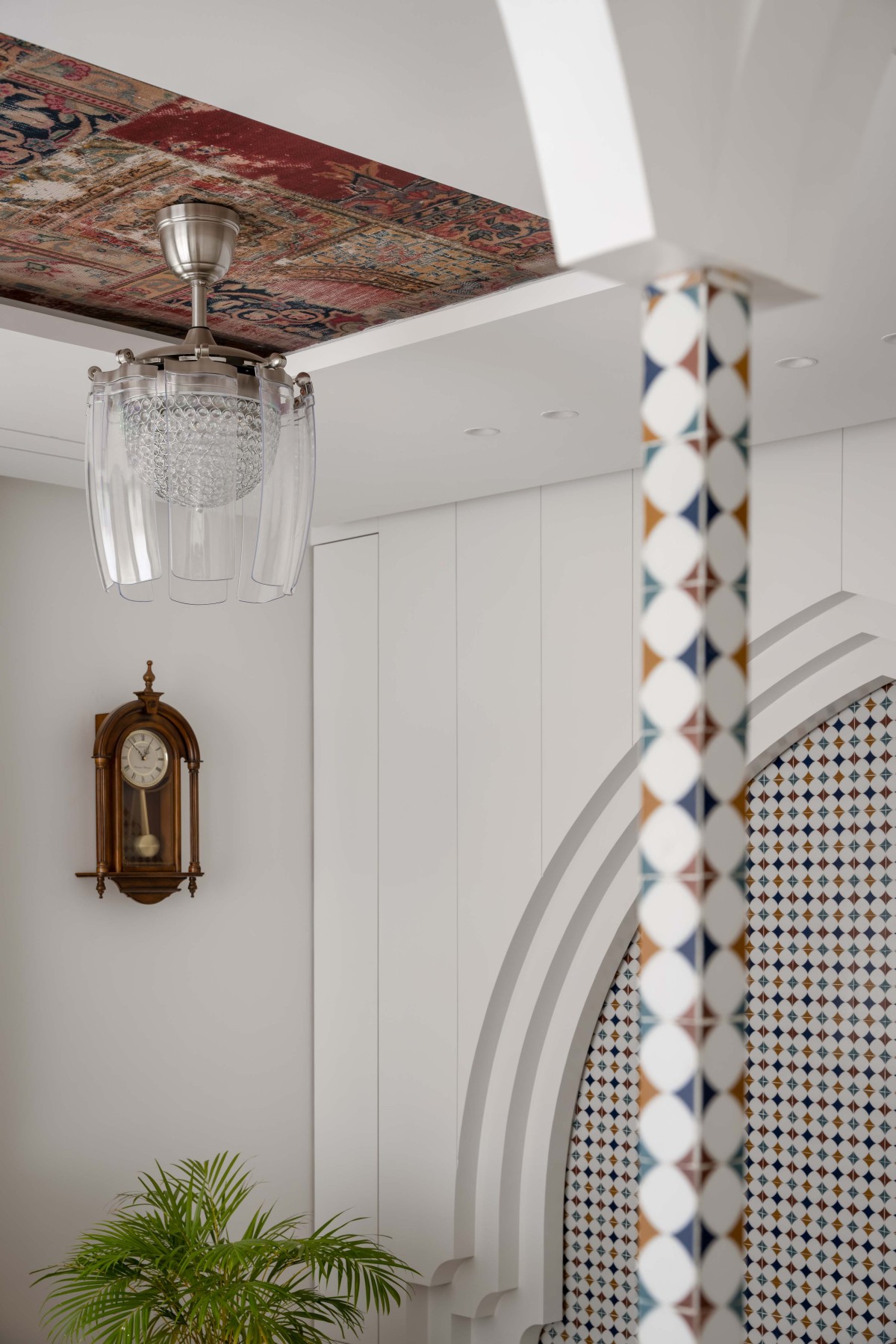 A quitessential detail shot capturing the mehraab, arch, columns, the ceiling rug laminate and chandelier