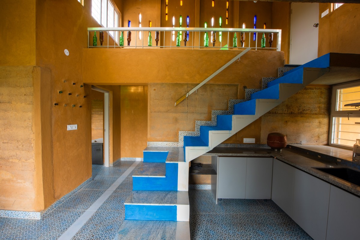 Kithchen and Staircase of Composite Earth Farmhouse by Studio Verge