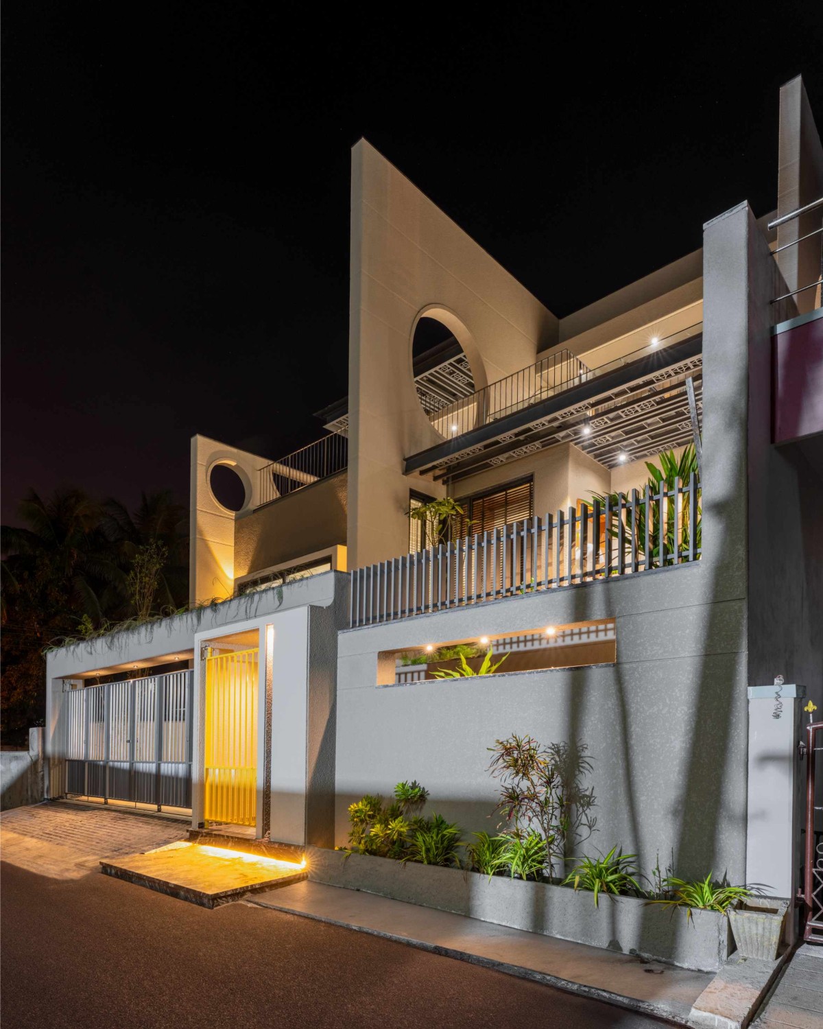 Dusk light exterior view of House of Parallel Walls by Aakar Group of Consultancy