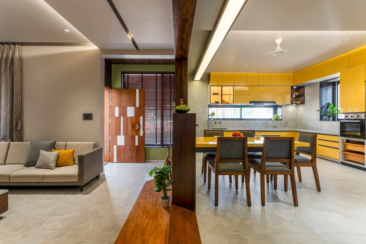 Living, Dining and Kitchen of House of Parallel Walls by Aakar Group of Consultancy