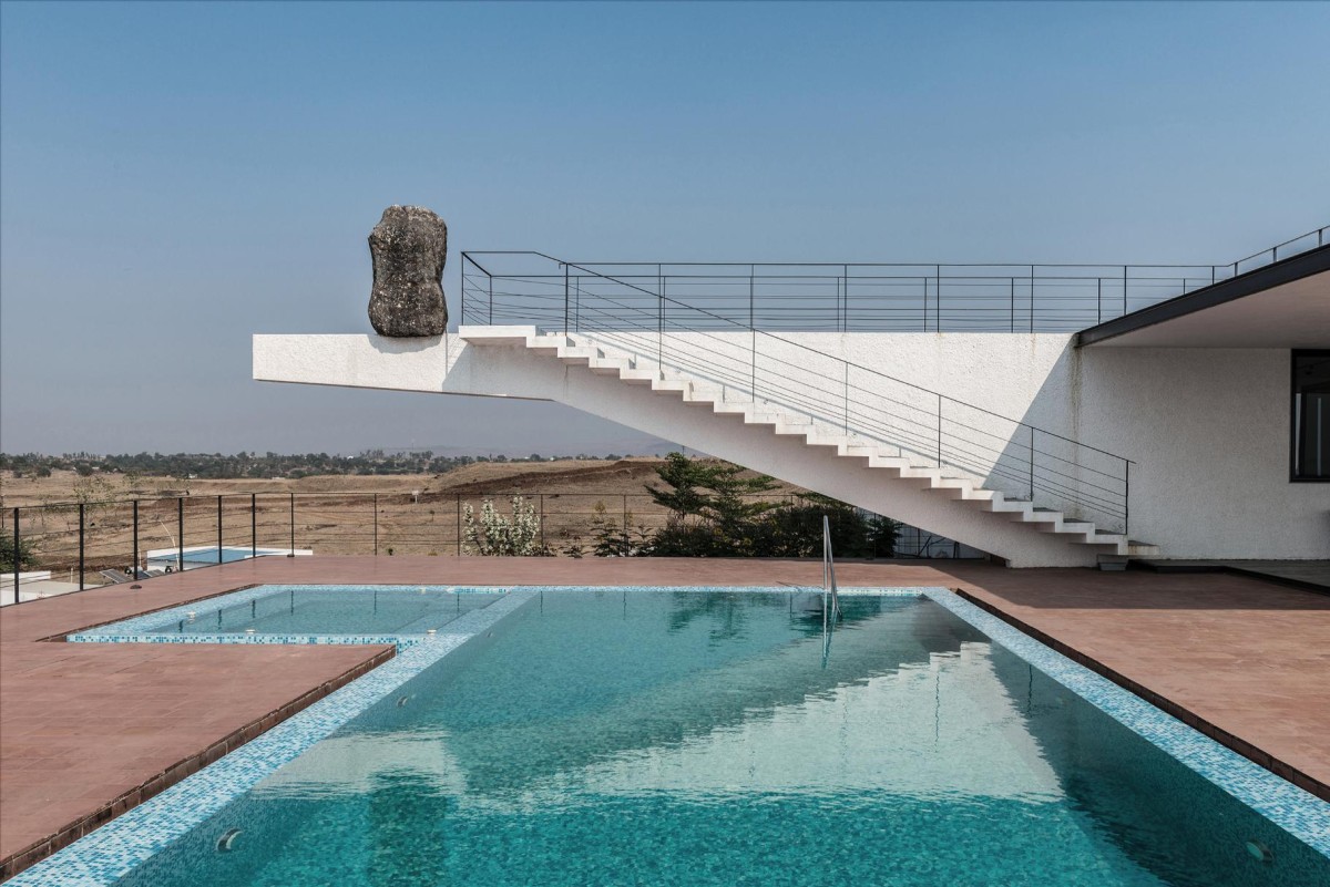 Pool view of House with the Soaring Rock by SPASM Design Architects