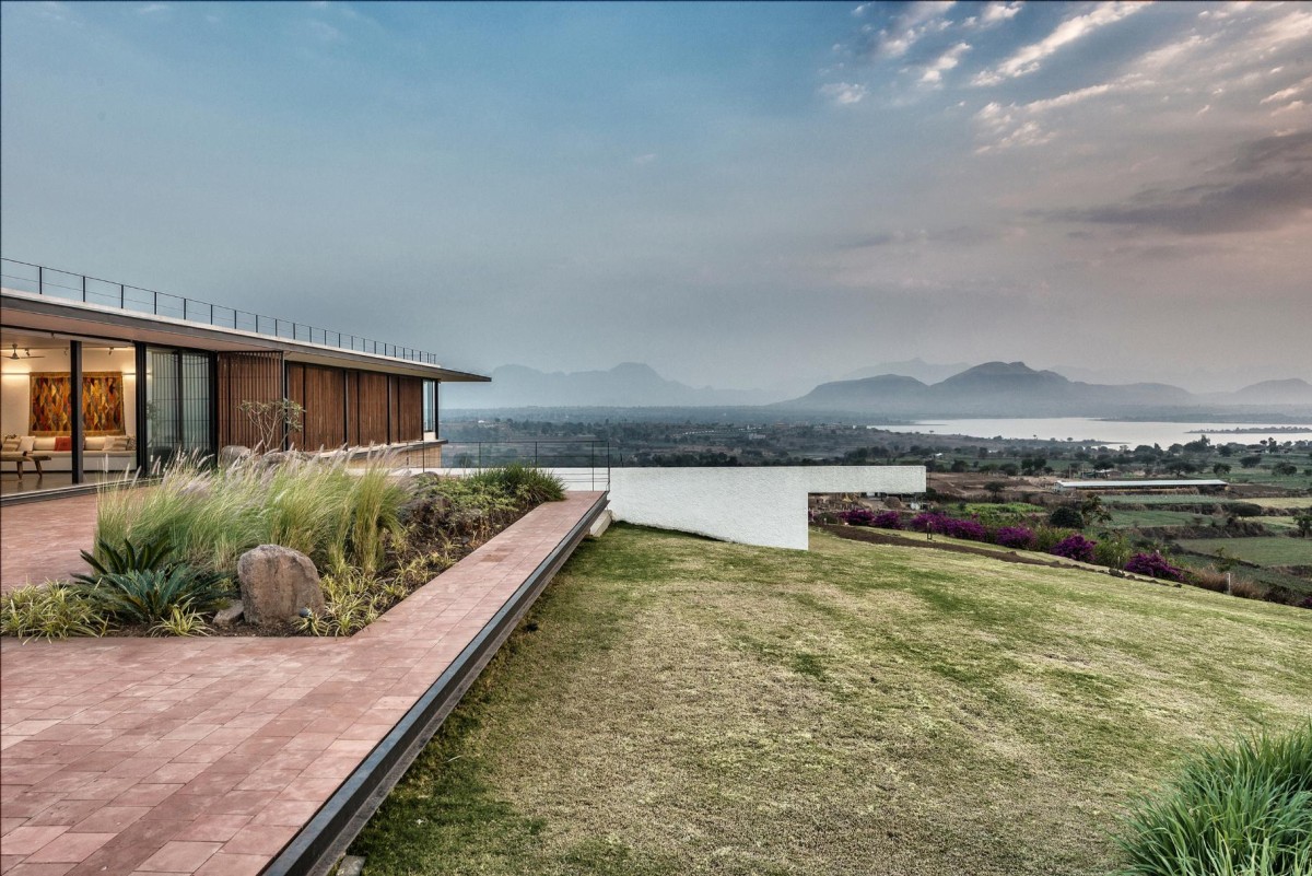 Landscape of House with the Soaring Rock by SPASM Design Architects