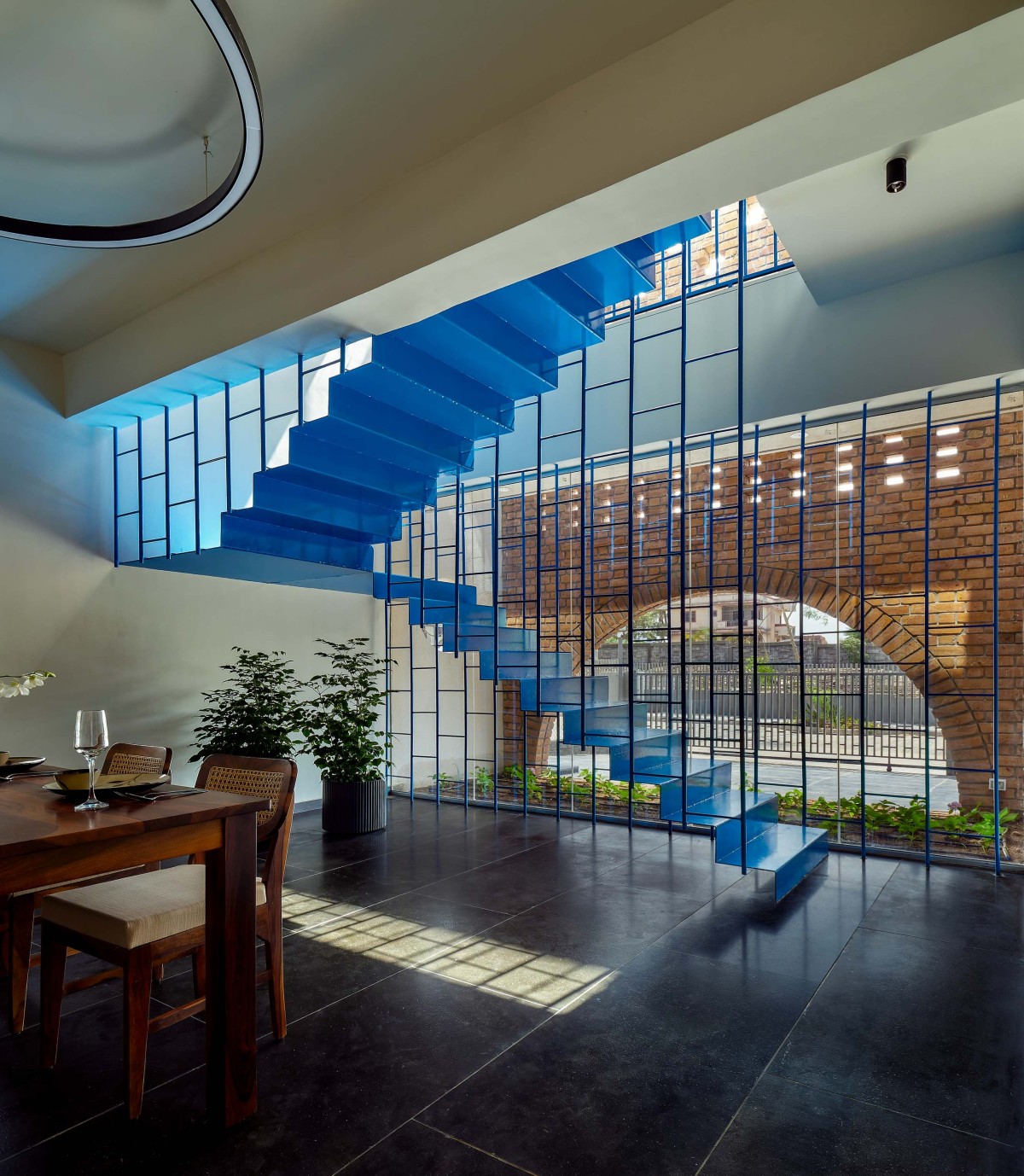 Blue Staircase and Courtyard of Within Cuboids by Alok Kothari Architects