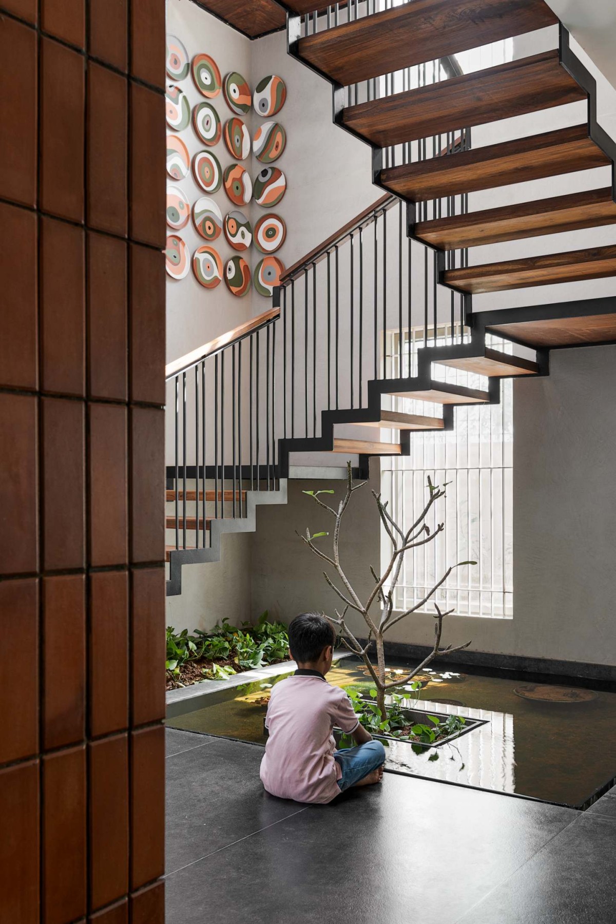 Passage to waterbody of Utsaha Residence by Kosh Studios