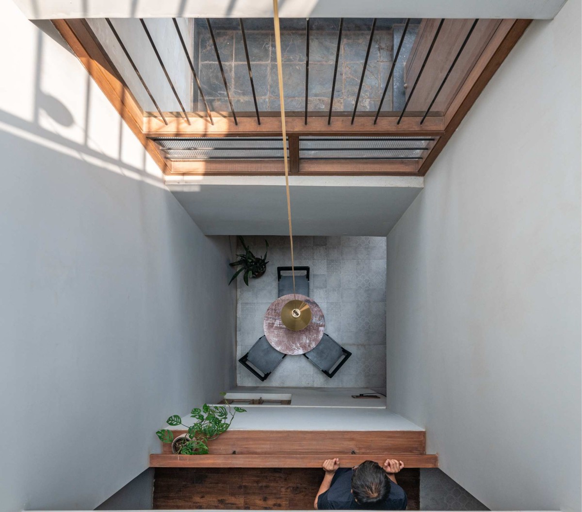 View of dining area from upper floor of Compact House by Rahul Pudale Design