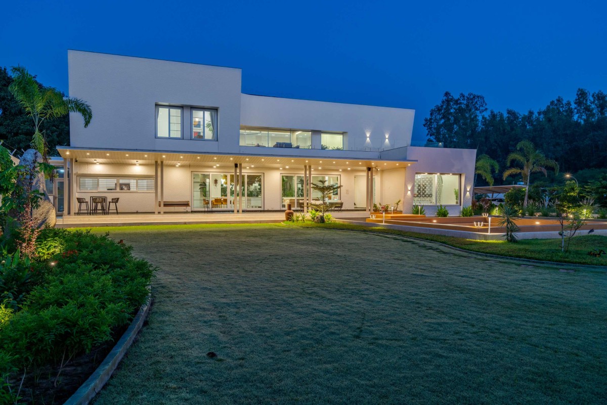 Dusk light exterior view of Sri Sri Villa by Ace Associates