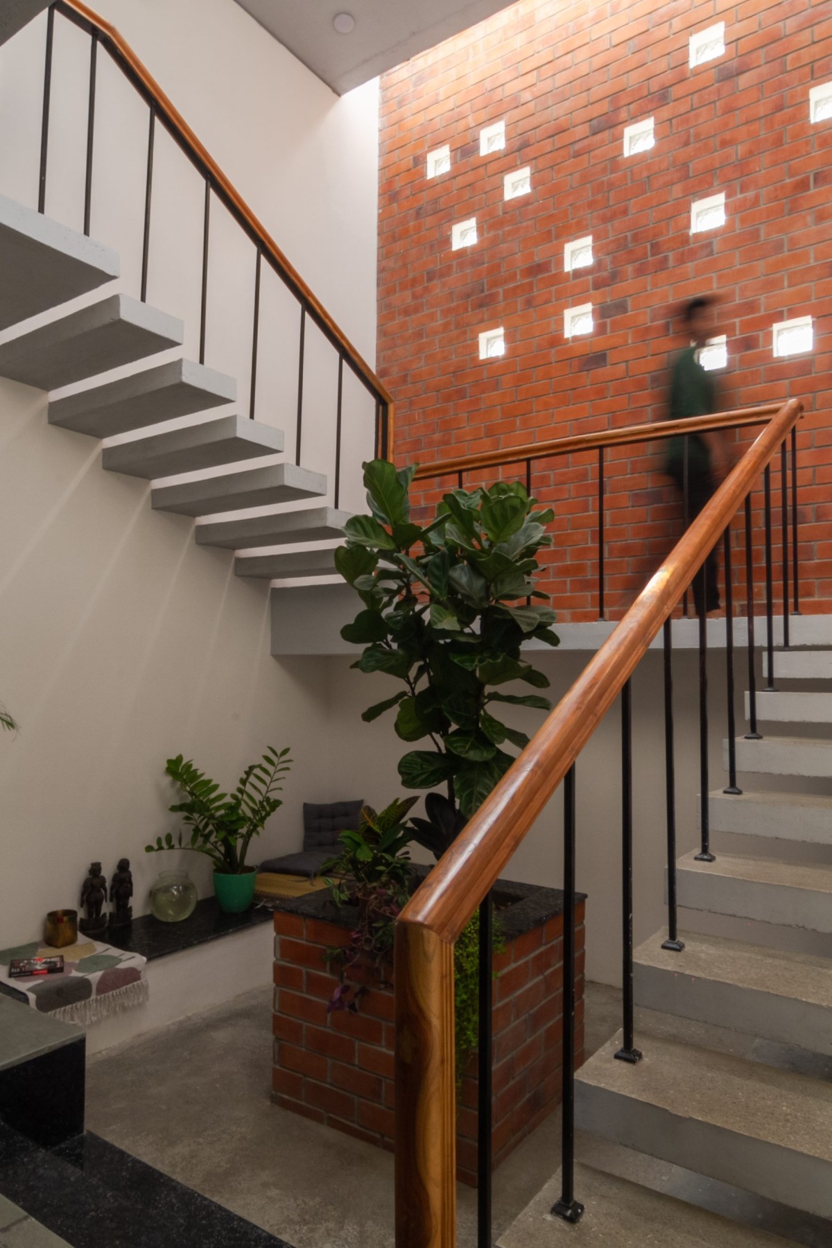 Central staircase court filled with filtered natural light through skylights and glass block windows