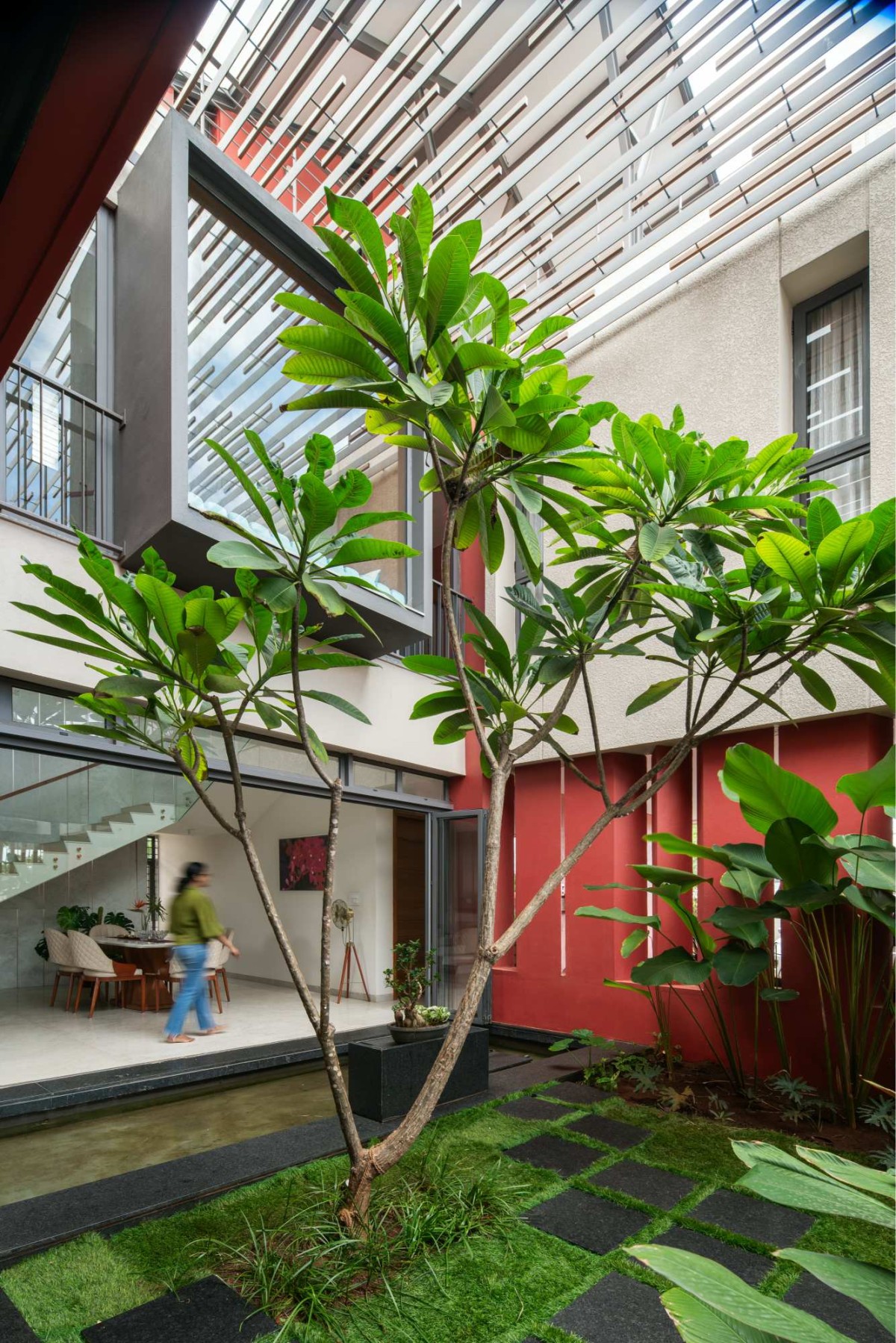Double height Courtyard of The Red Courtyard House by Jacob + Rathodi Architects