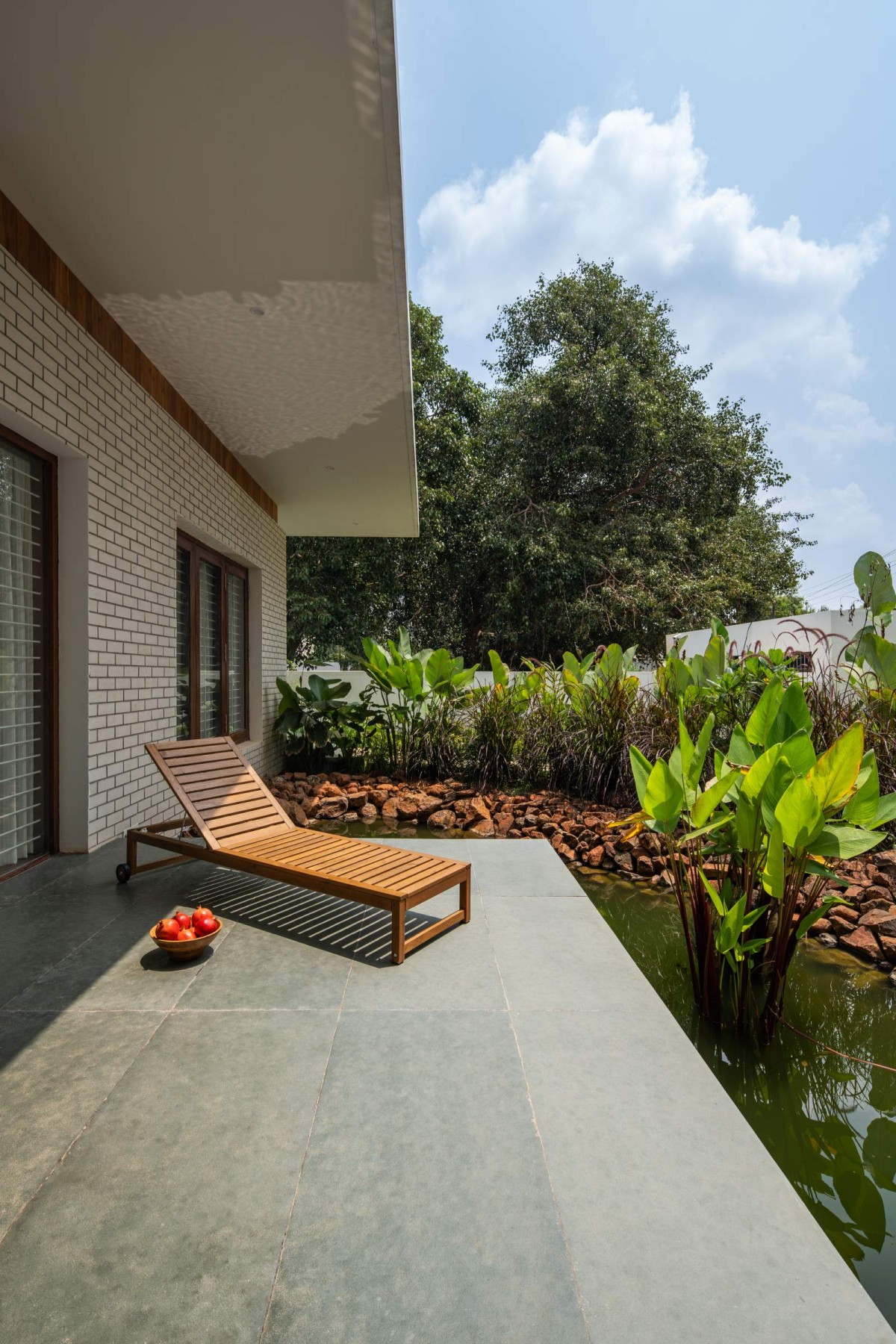 Deck and Pond of The Modern Pastoral House by Sudaiva Studio