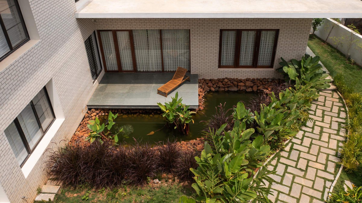 Top View of Deck and Pond of The Modern Pastoral House by Sudaiva Studio