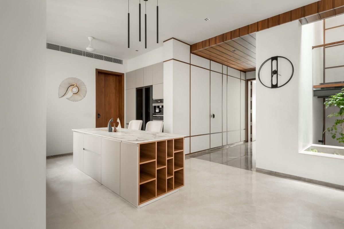 Modern kitchen with island of Veera Villa by Keystone Studio