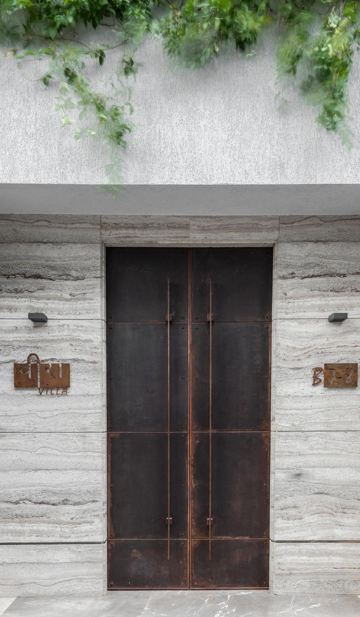 Beautiful rust-based main door of Veera Villa by Keystone Studio