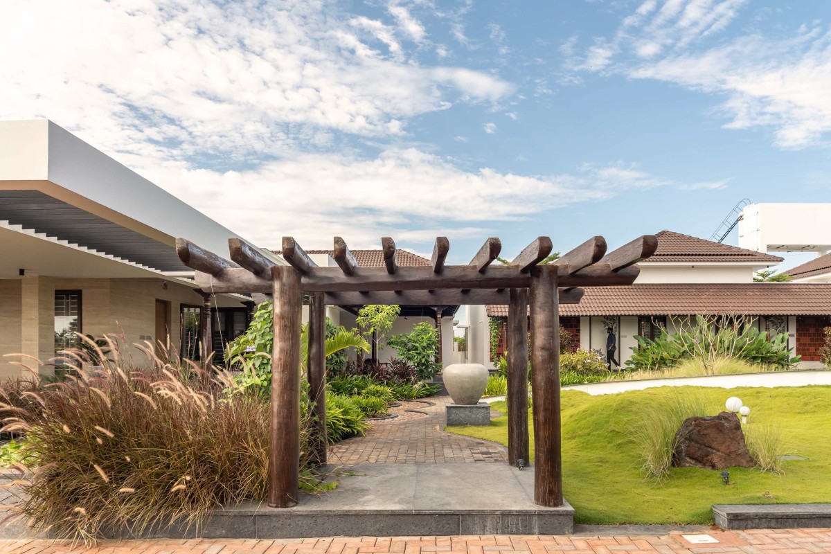 A pine wood pergola placed for vasthu reasons , made into a elegant entry to the central landscape