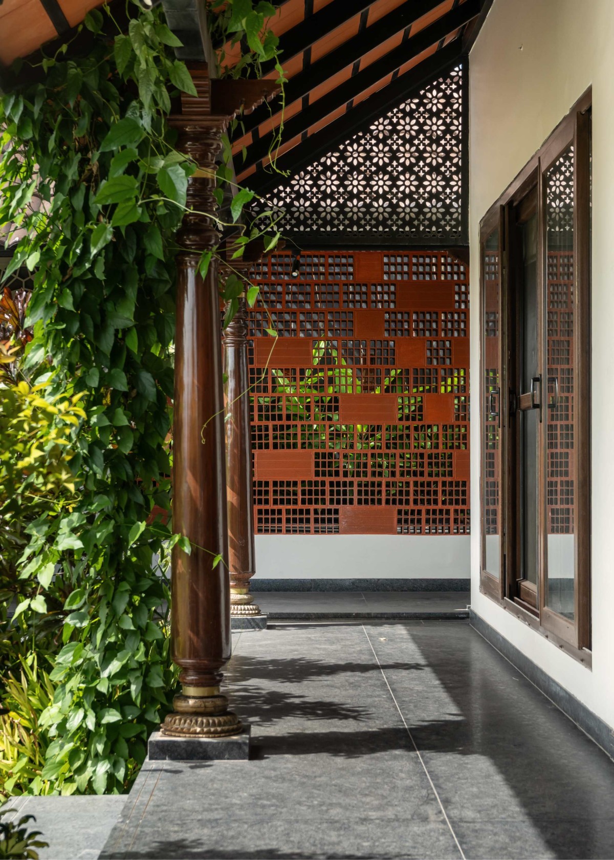 A view of creepers growing over the Chettinad columns embracing the corridors