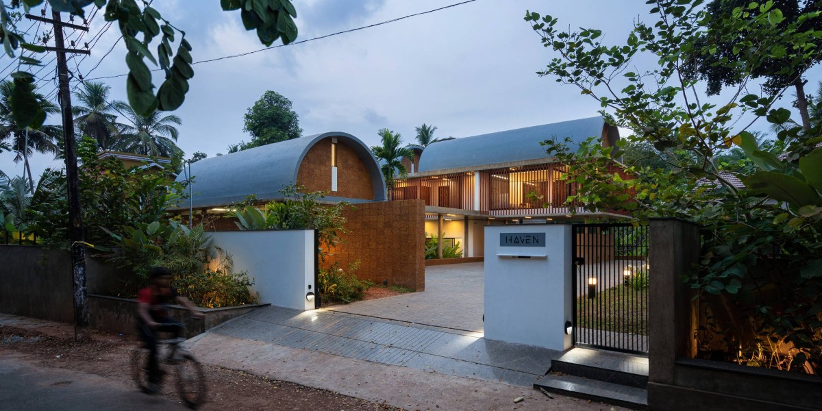 Dusk light exterior view of The Stoic Wall Residence by LIJO.RENY.architects