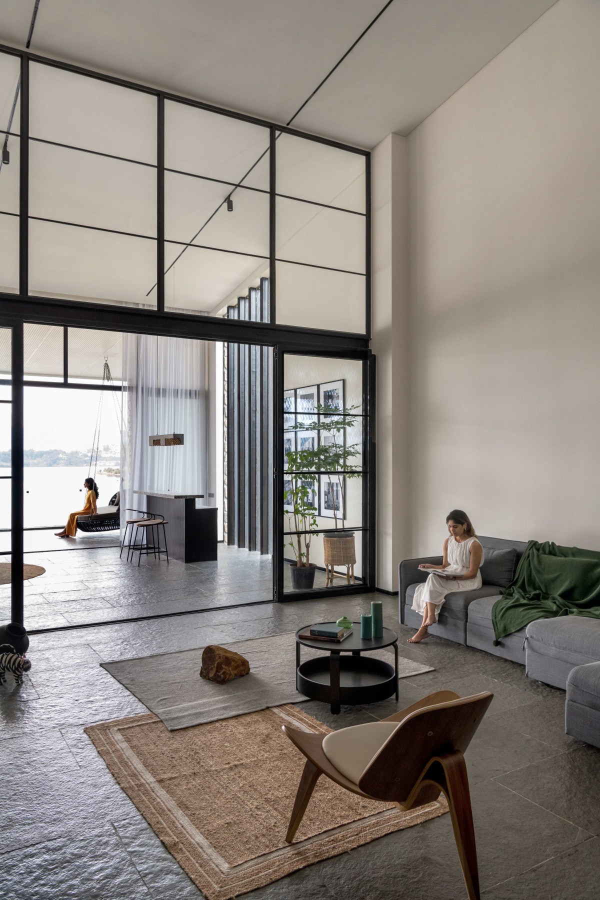 View from the TV Room into the living space of House by the Lake by Kaviar Collaborative