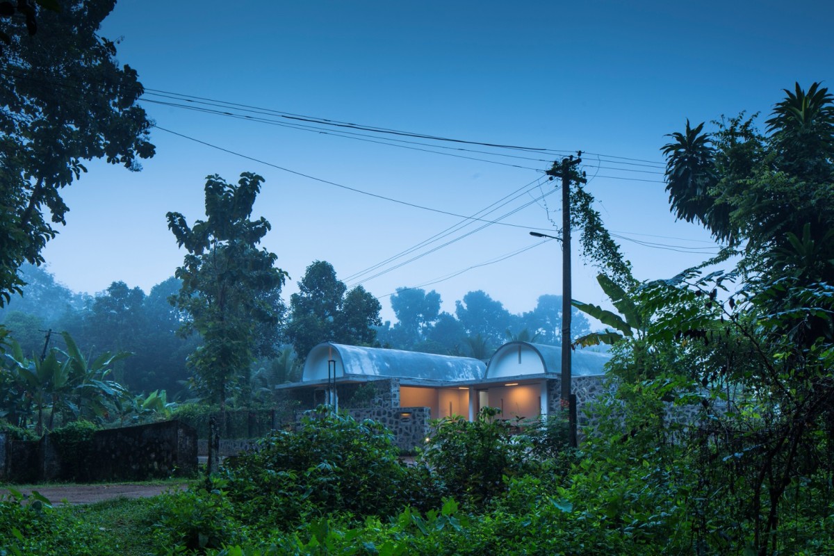 Dusk light exterior view of The Walls and Vaults House by LIJO.RENY.architects