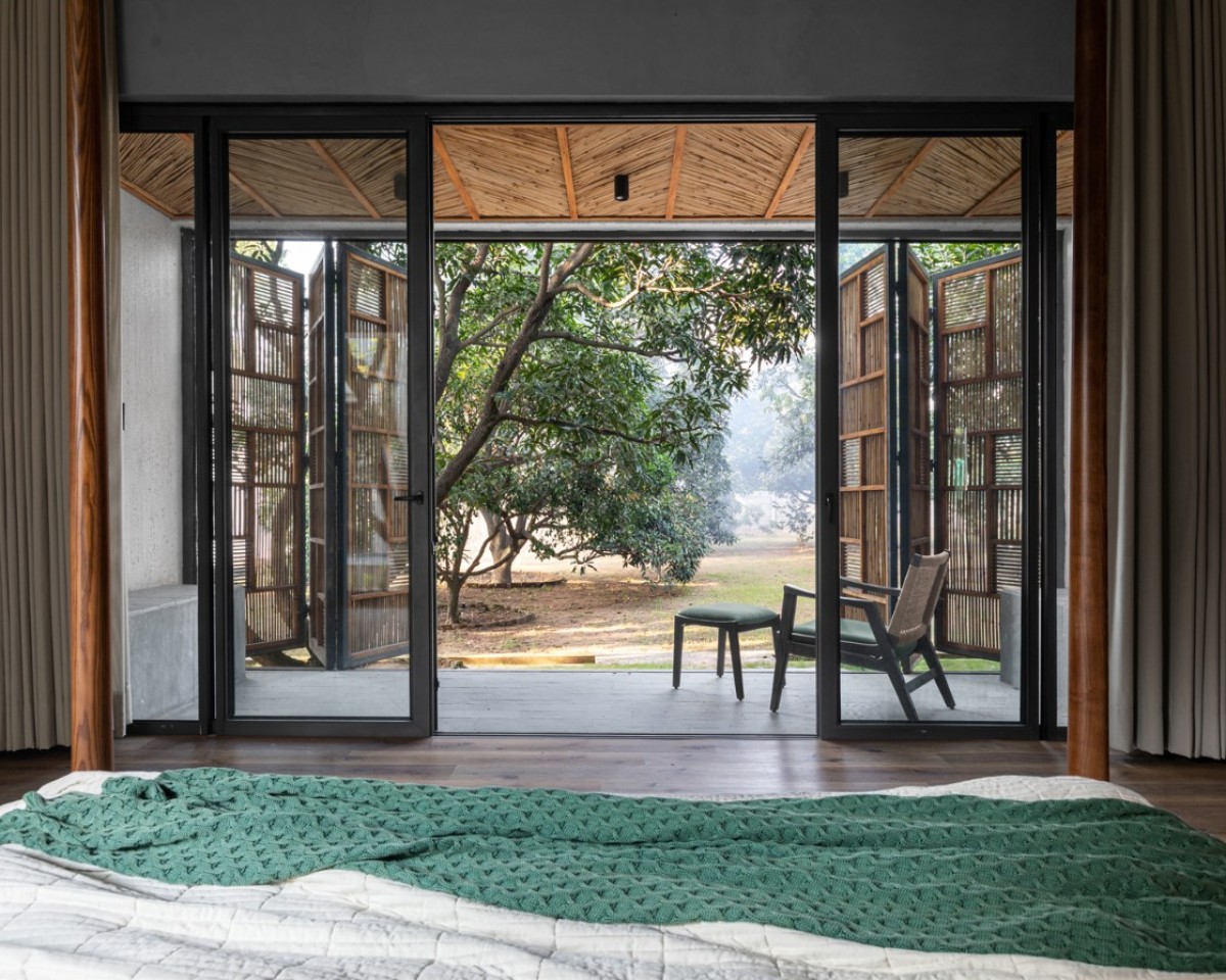 Bedroom 2 of House of Mango Shadows by Design i.O Architects