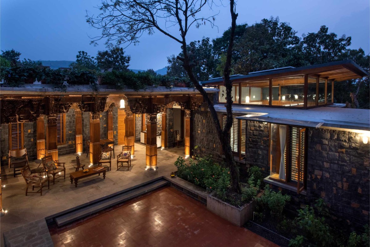 Dusk light shot of private court of A Farmhouse At Mahiravani by Environ Planners