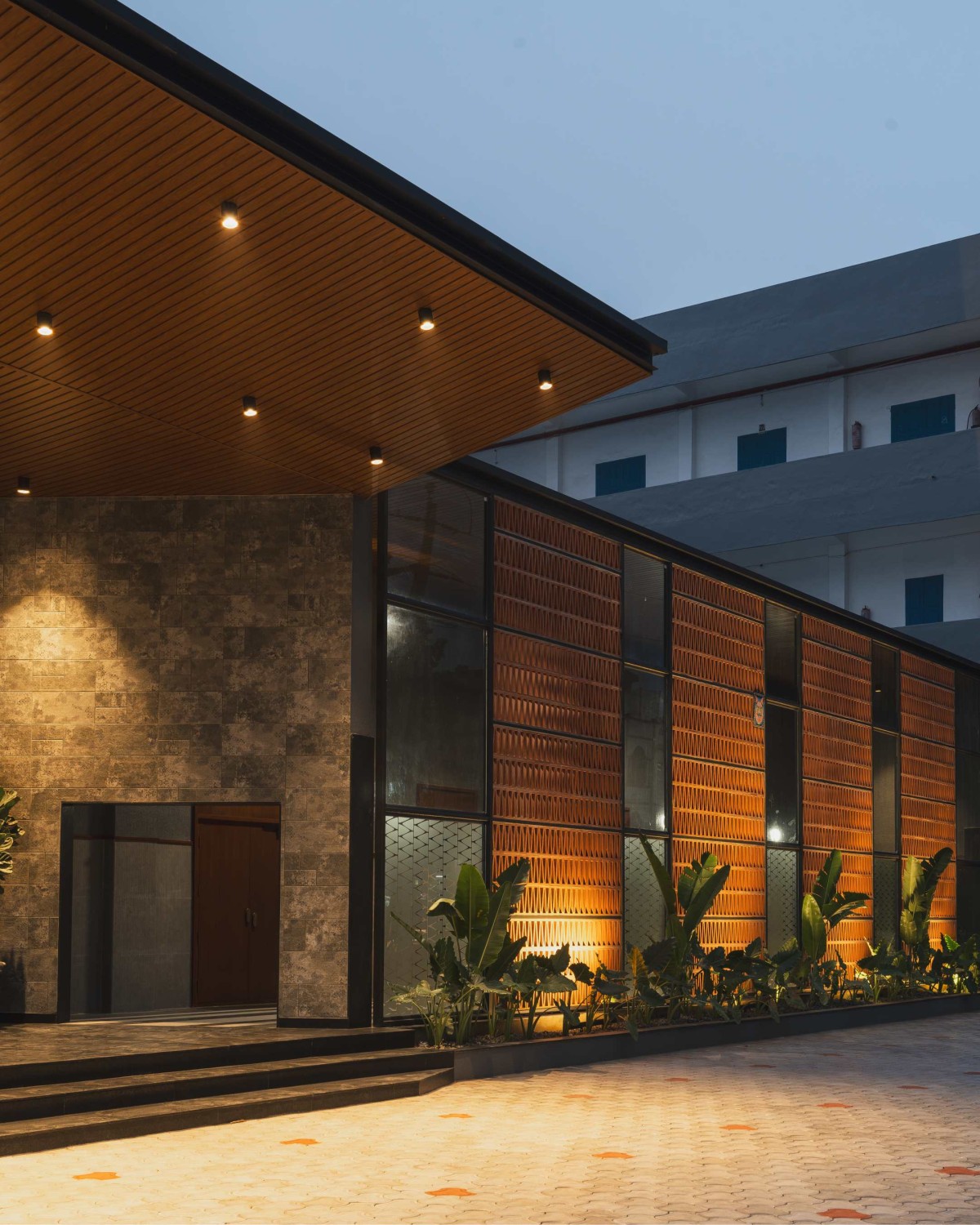 Dusk light exterior view of JKC Auditorium by Dimensions