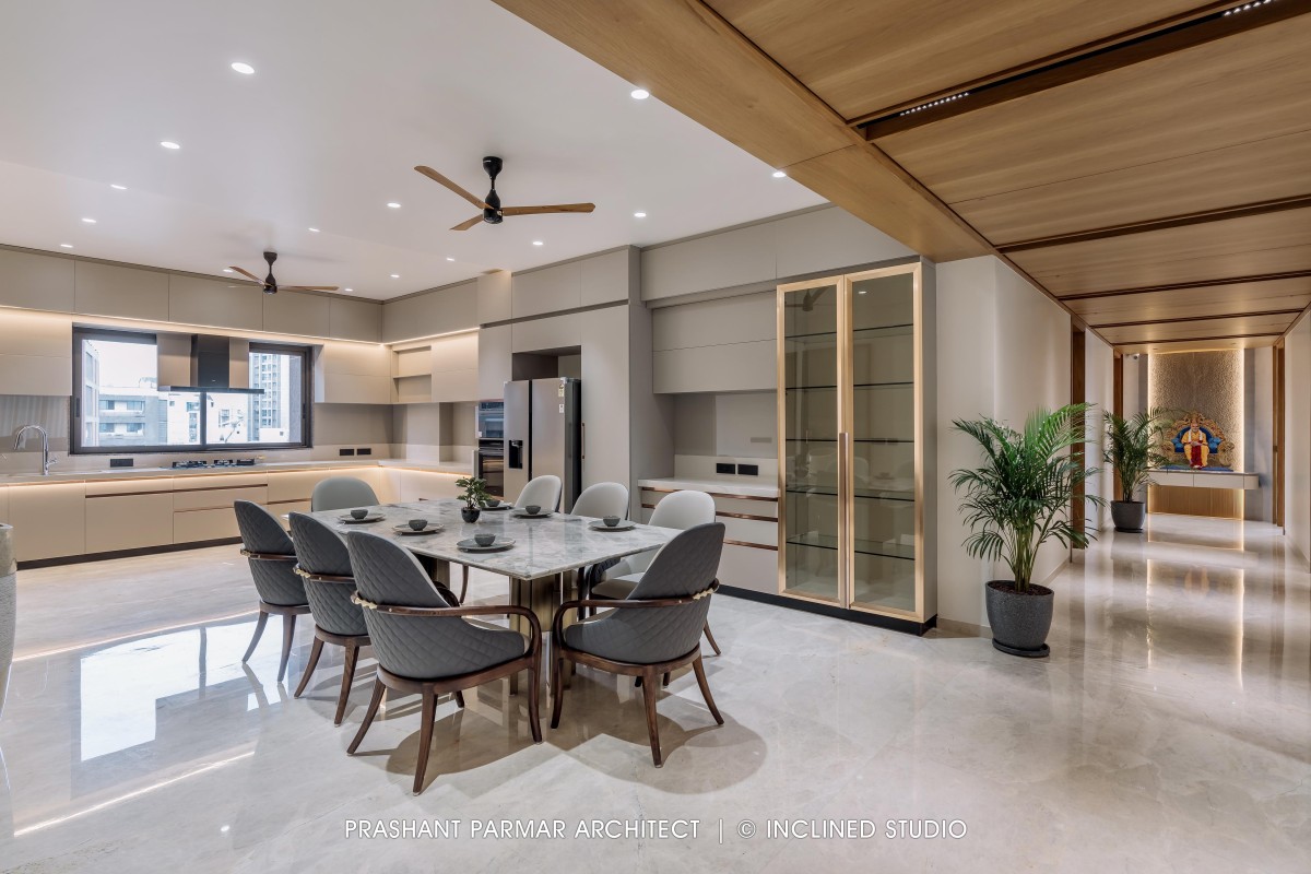 Dining & Kitchen of 4BHK Timeless Interiors at Skara Divyam by Prashant Parmar Architect