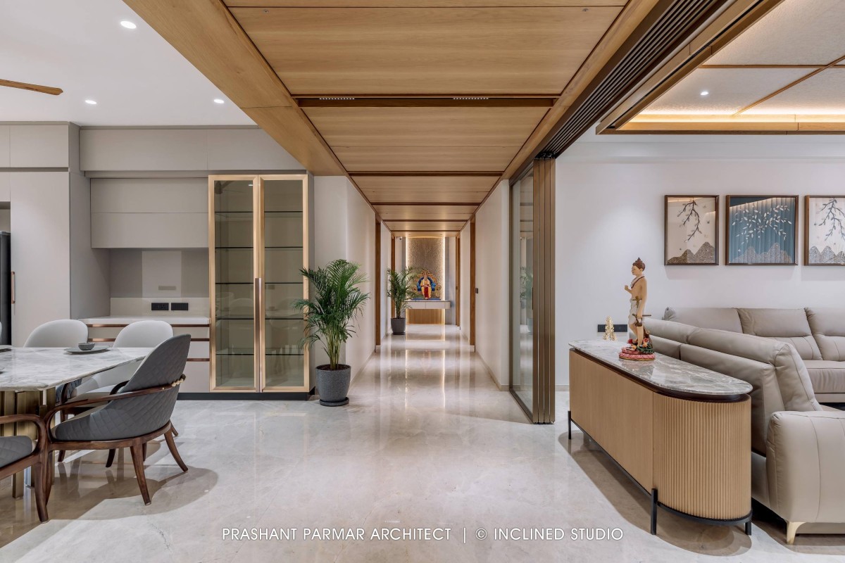 Passage between living & dining area of 4BHK Timeless Interiors at Skara Divyam by Prashant Parmar Architect