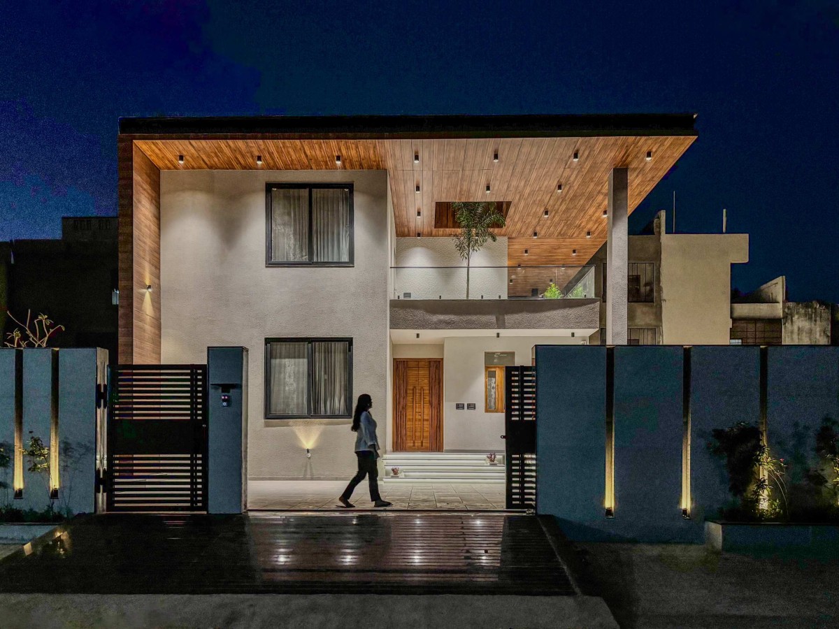Night exterior view of The Lightwell Farmhouse by Studio Symposium
