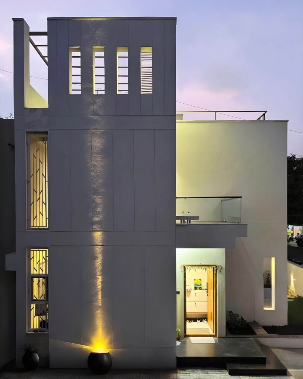 Dusk light exterior view of Saksham by DESiGN fEEDER Architects