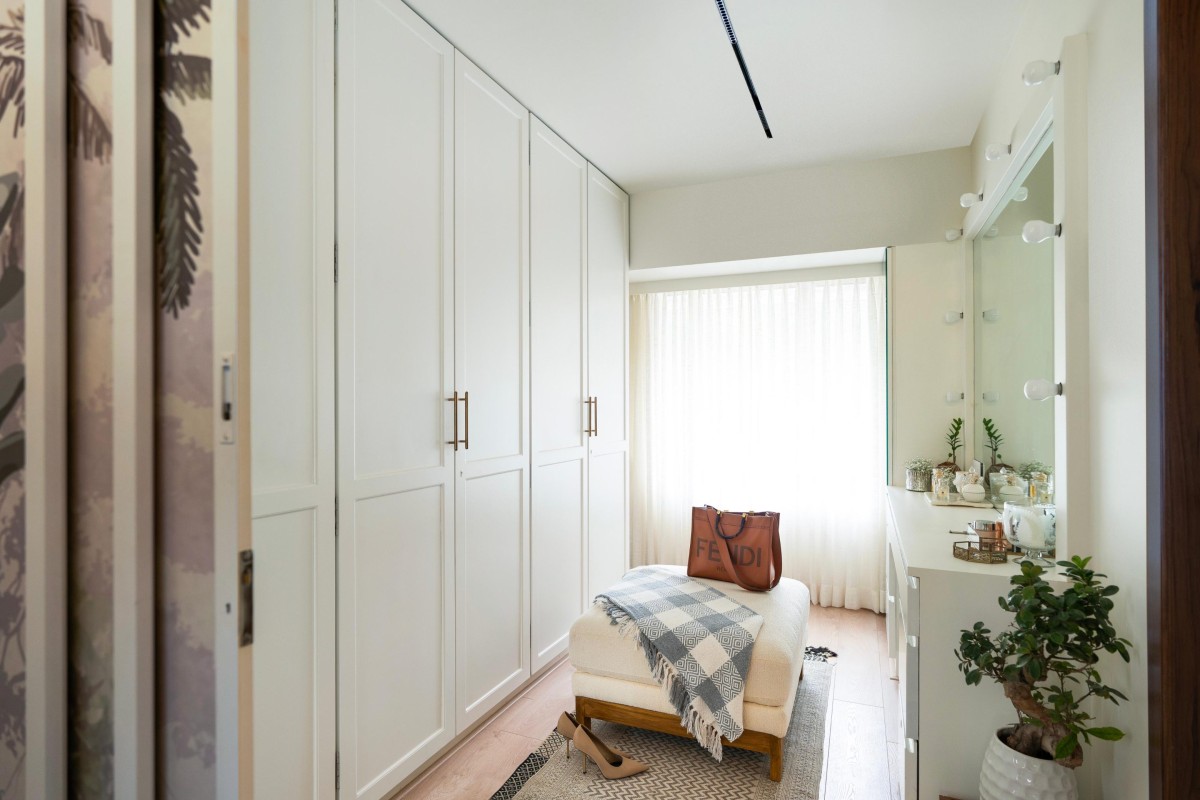 Walk-in closet opens up to enlarge the bedroom of Maison Blanche by Oris Architects