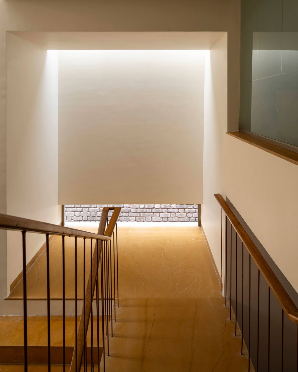 Staircase mid-landing beneath a skylight’s embrace of The Enfold by Studio Biosis